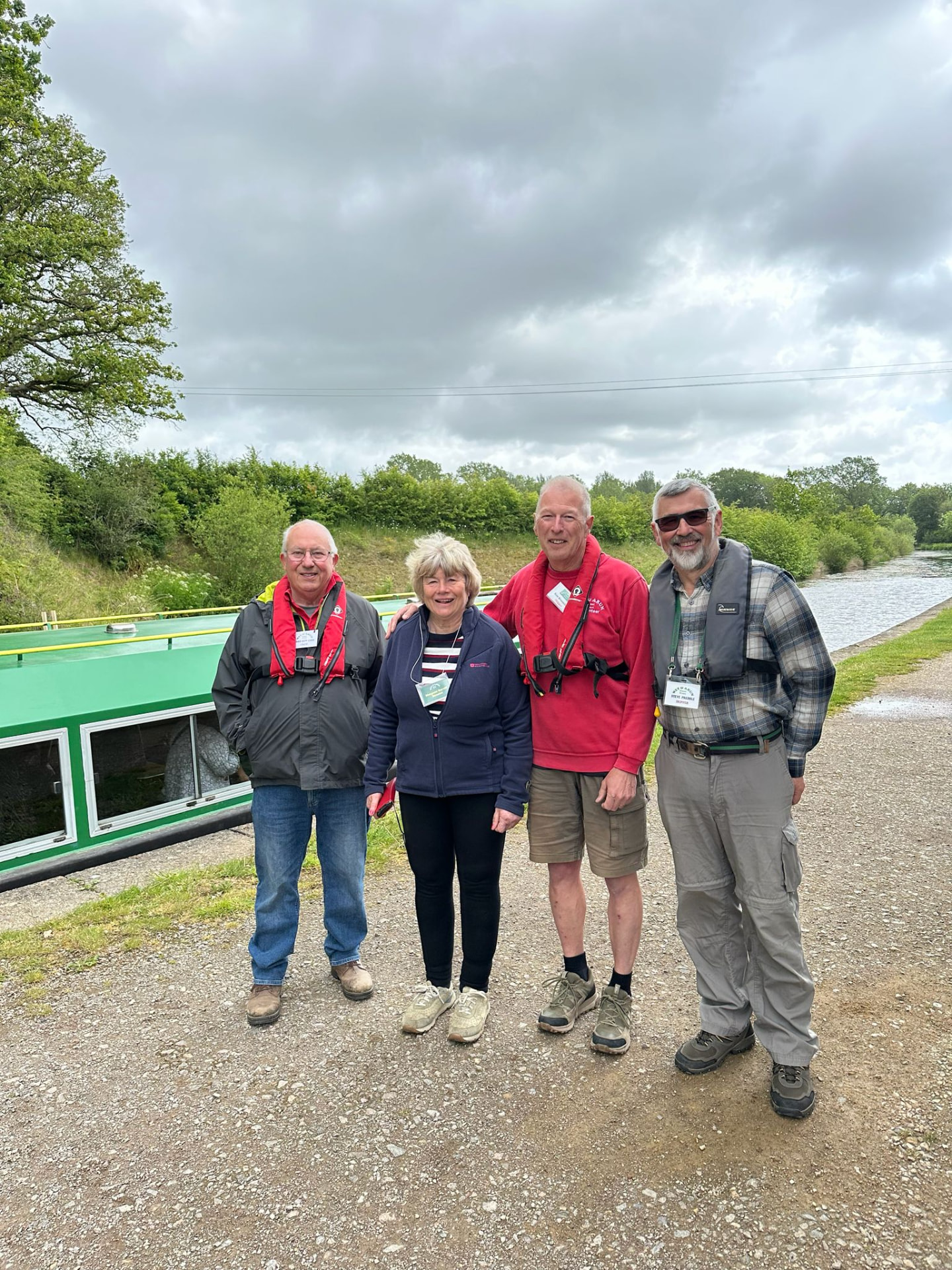 Members and volunteer crew photographed on the towpath beside their canal boat