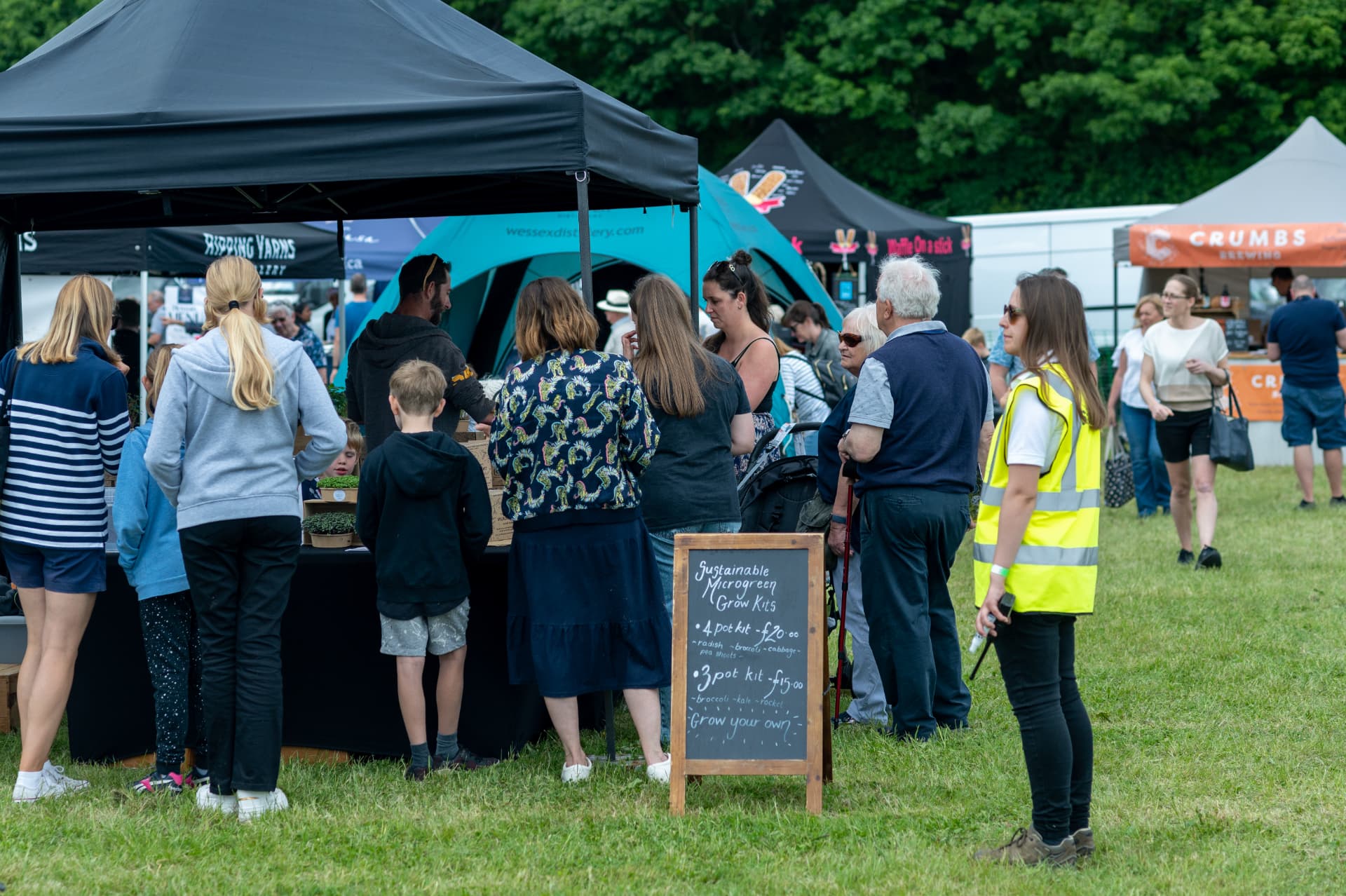 Visitors browsing local producer stalls at a Surrey Hills artisan festival
