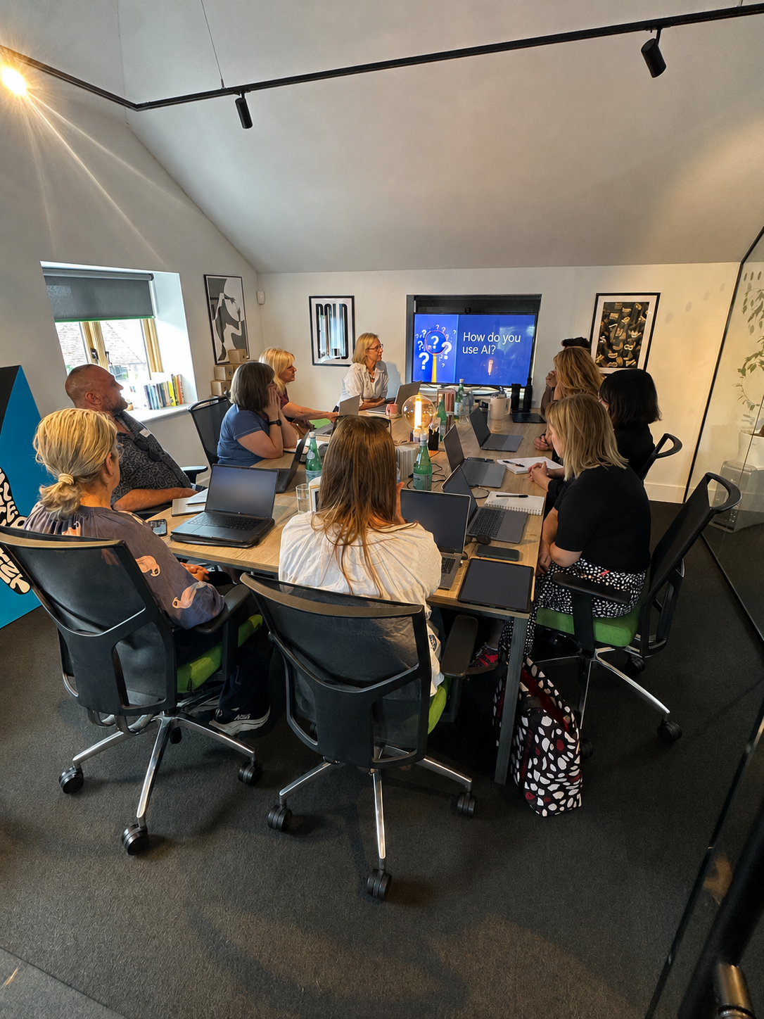 Members around a boardroom table during a practical AI workshop