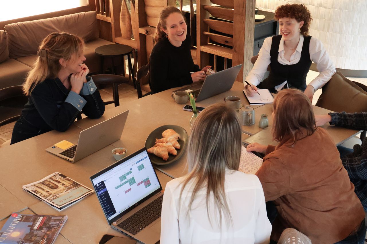 Surrey Hills Enterprises members working together around a table at The Boathouse