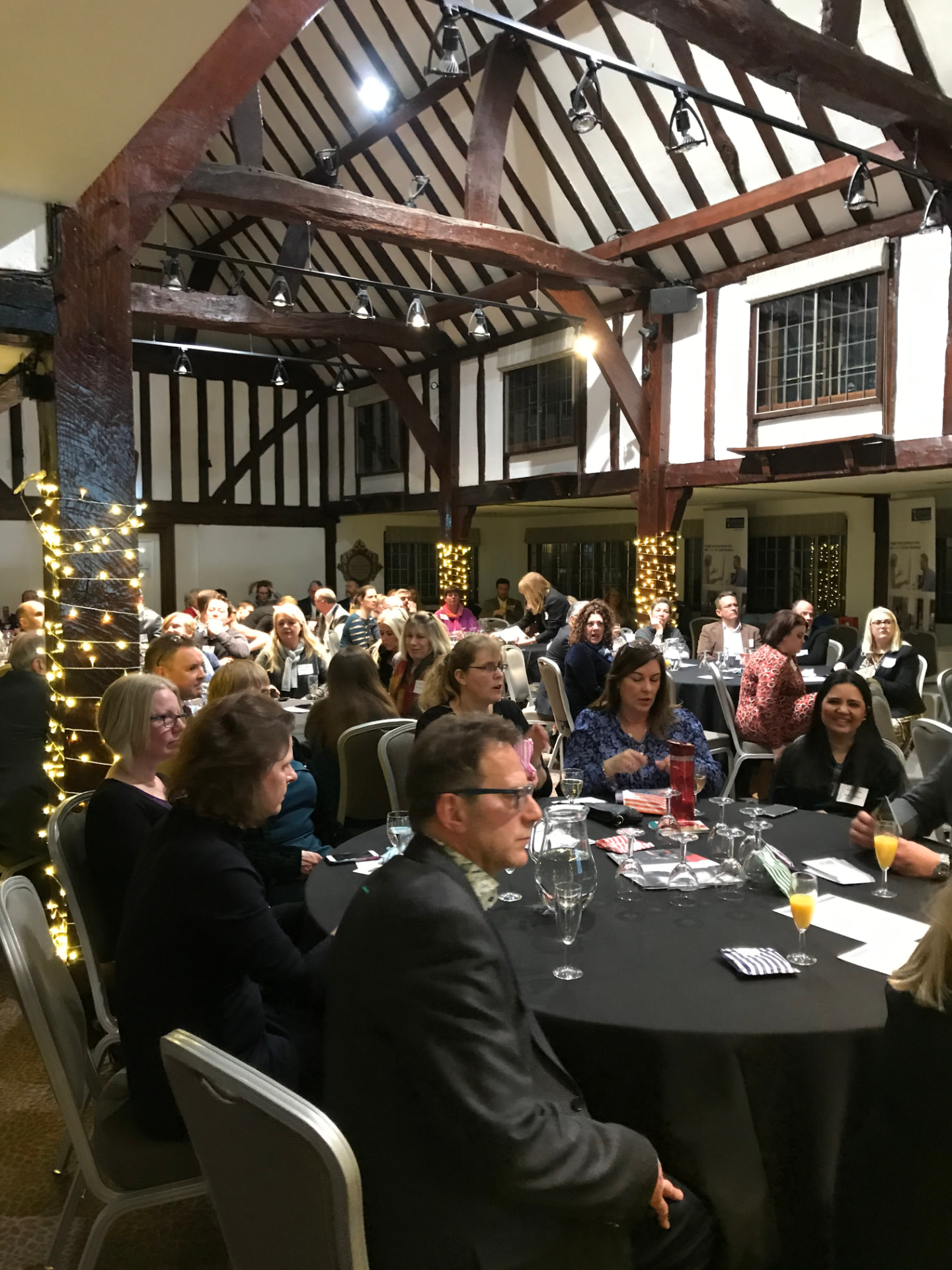 Members seated at round tables during an awards evening at Burford Bridge