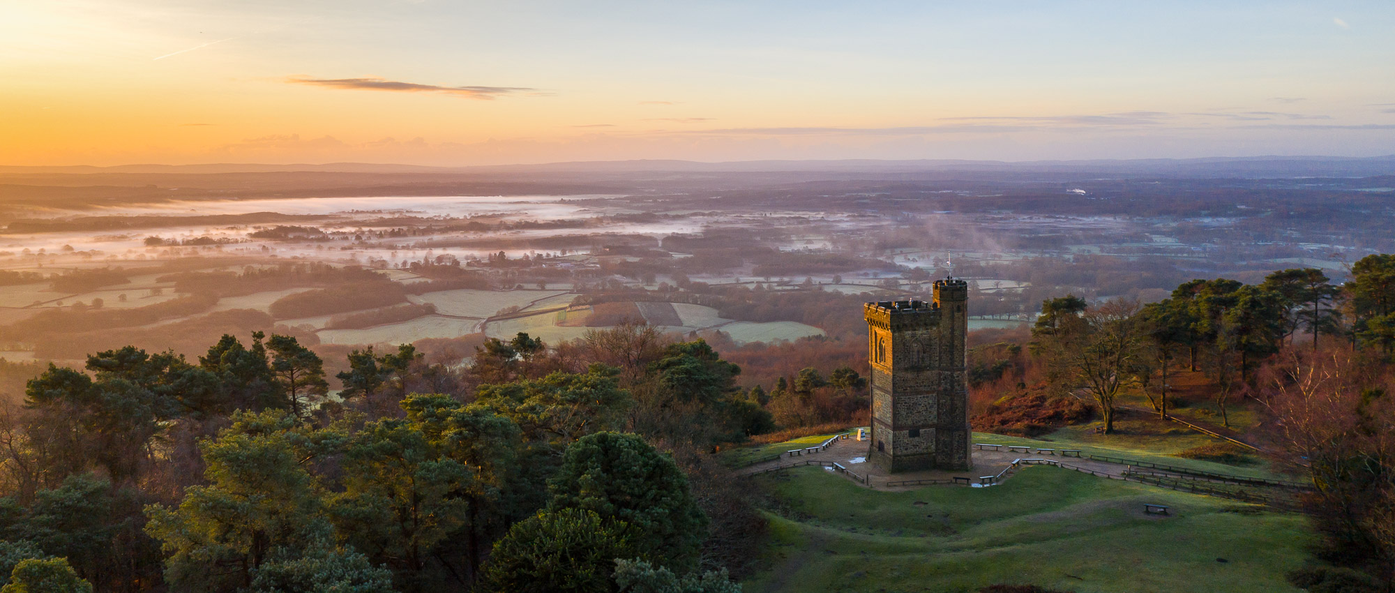 Leith Hill Tower at sunrise above mist-filled Surrey Hills countryside